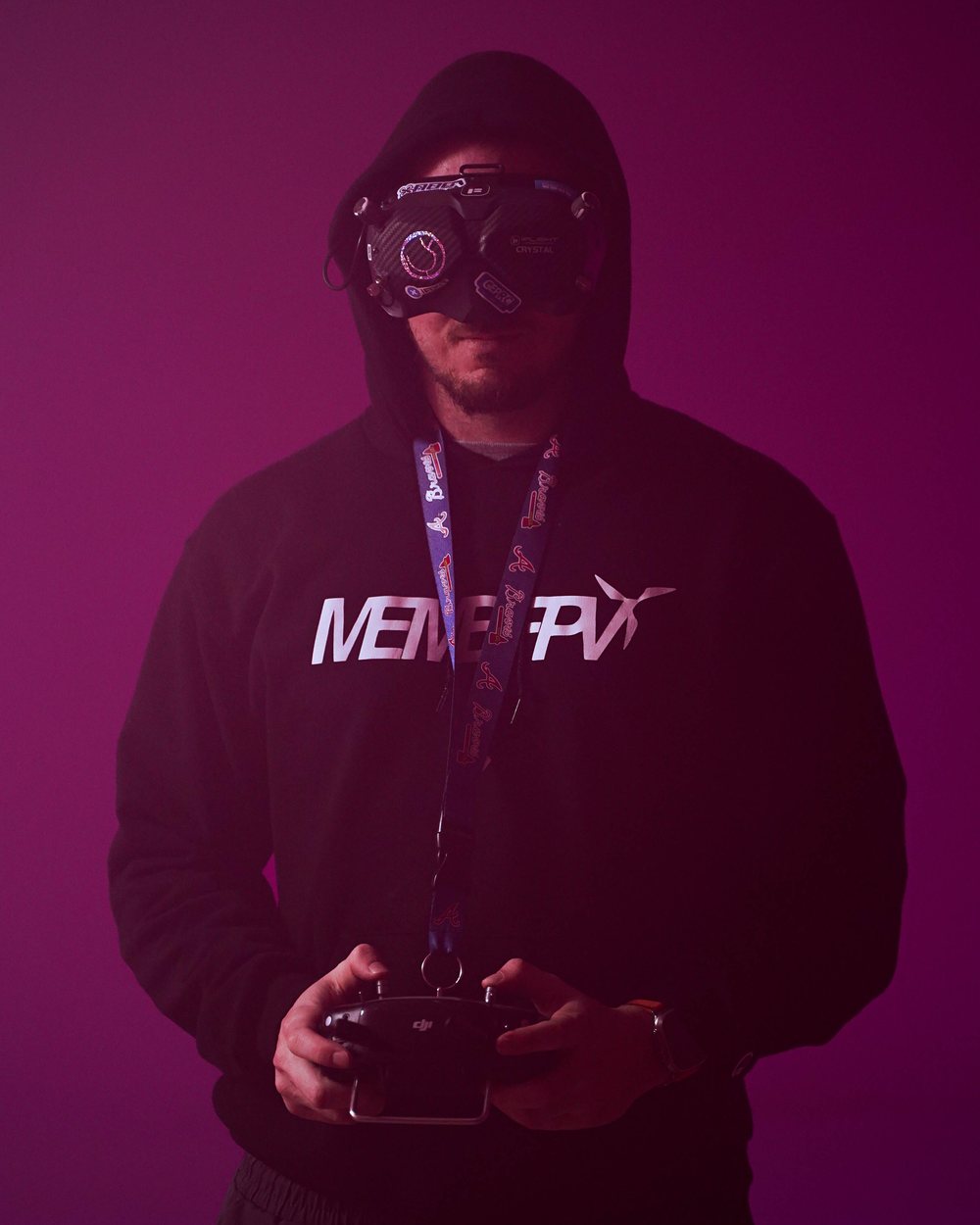 Mike in a MemeFPV hoodie wearing FPV goggles and holding a controller